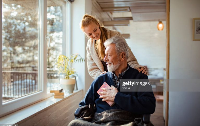 Close up of a granddaughter helping her grandfather around the house